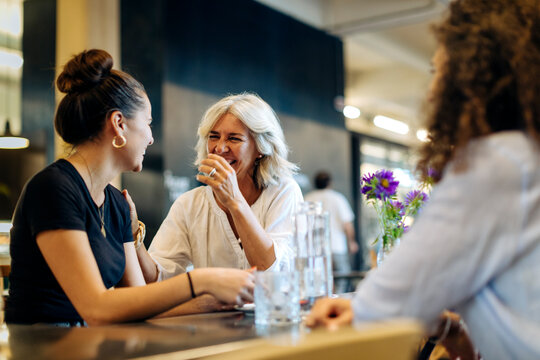 Women meeting in bistro, having fun