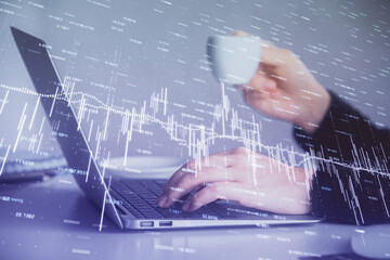 Double exposure of businesswoman hands typing on computer and forex graph hologram drawing. Financial analysis concept.