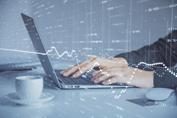 Fototapeta premium Double exposure of businesswoman hands typing on computer and forex graph hologram drawing. Financial analysis concept.