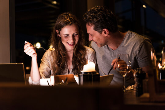 Smiling couple having dinner together