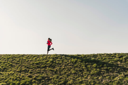 Young woman running on rural path
