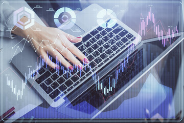 Double exposure of businesswoman hands typing on computer and financial graph hologram drawing. Stock market analysis concept.