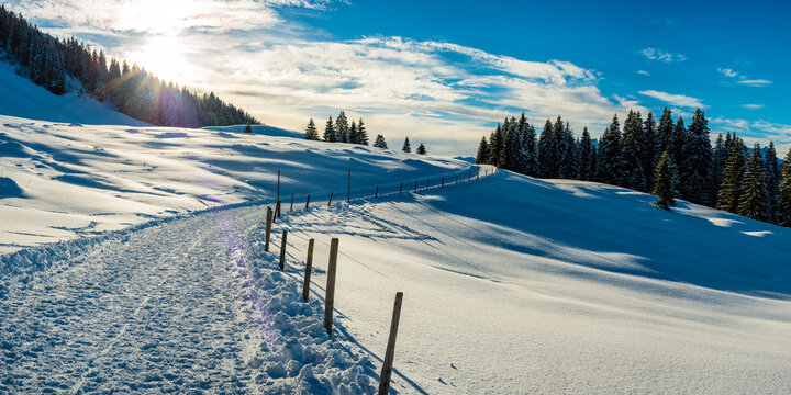 Sun setting over snow-covered footpath in&Ocirc;&oslash;&Omega;Kleinwalsertal