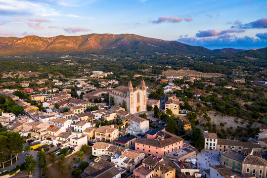Spain, Mallorca, Calvia, Helicopter view of Parroquia Sant Joan Baptista church and surrounding buildings at dusk