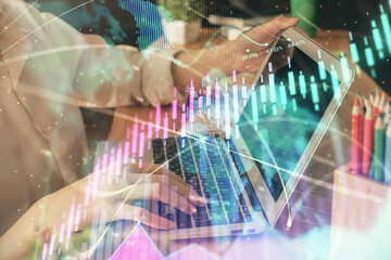 Double exposure of woman hands typing on computer and forex chart hologram drawing. Stock market invest concept.