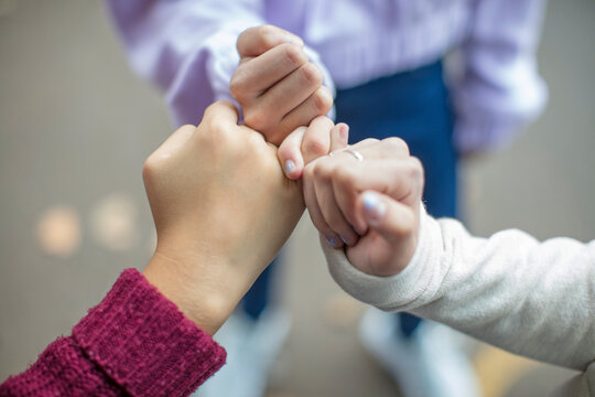Close-up of teenage girls making a pinky promise