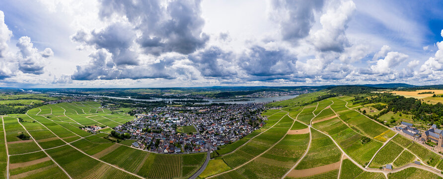 Germany, Hesse, Eibingen, Helicopter panorama of clouds over rural town surrounded by vineyards in early autumn
