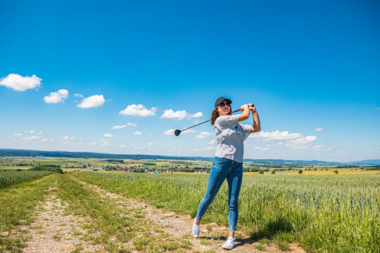 Young woman playing golf at countryside