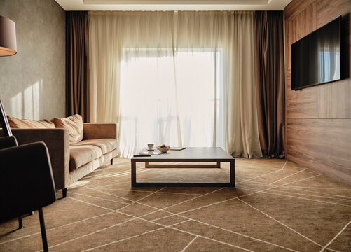 Coffee table with empty sofa in luxury hotel room