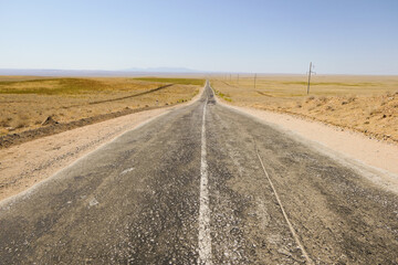 Fototapeta na wymiar Road in a dry landscape, Nurota, Uzbekistan