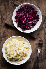 Bowl of red and white cabbage salad on table