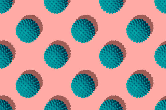 Teal balls arranged on coral background