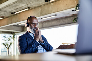 Businessman concentrating while working on laptop at home