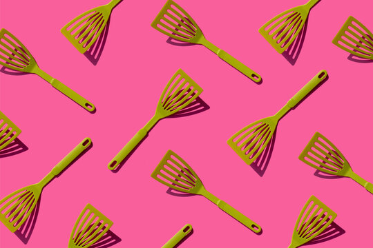 Pattern of green spatulas against pink background