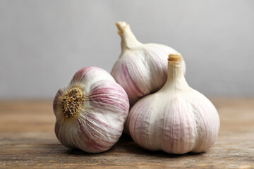 Fresh organic garlic on wooden table, closeup