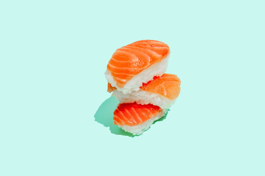 Fresh salman sushi nigri on mint green background