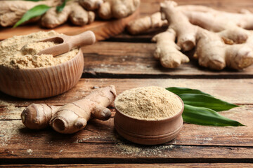 Dry ginger powder, fresh root and leaves on wooden table