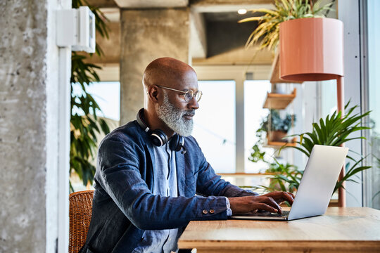 Mature man doing freelance work while sitting at home