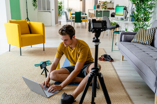 Fitness trainer making arrangement for live streaming while sitting at home