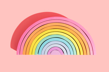 Colorful semi-circle rainbow toy on pink background
