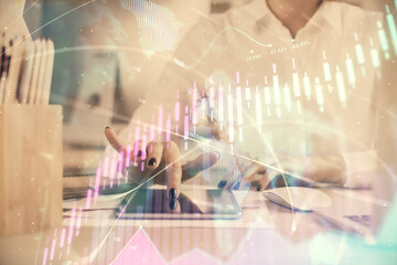 Double exposure of forex chart sketch hologram and woman holding and using a mobile device. Financial market concept.