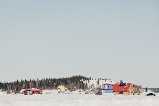 Cabins at the base of hill in wintertime.