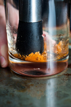 Bartender muddling Orange Peel