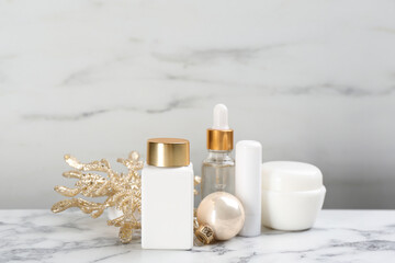 Fototapeta na wymiar Beautiful composition with cosmetic products on white marble table. Winter care