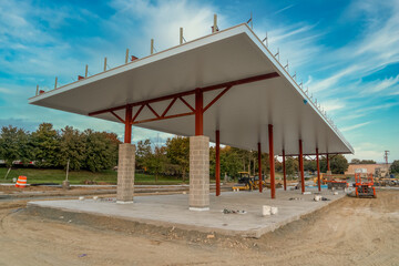 Newly built gas station in the USA with red steel beams holding up the white cover