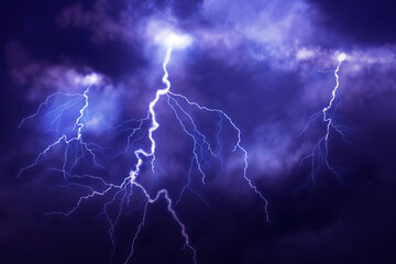 Naklejka na ściany i meble Lightnings in dark cloudy sky during thunderstorm