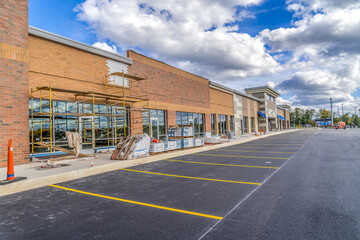 Refurbished strip mall commercial real estate property under construction in Maryland covered with...