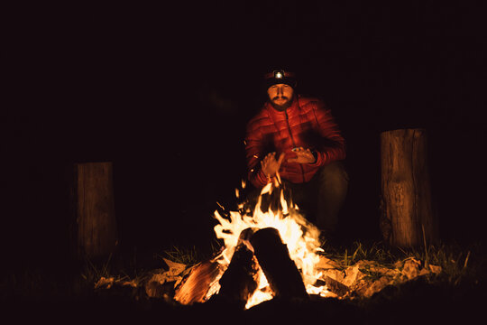 Man Warming Hands By Fire
