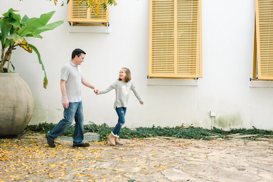 Portrait of father walking with daughter