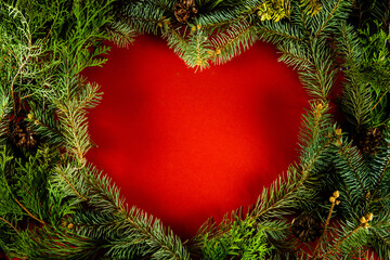 Creative layout with heart shaped Christmas branches. Nature Christmas background