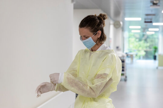 Nurse putting on gloves