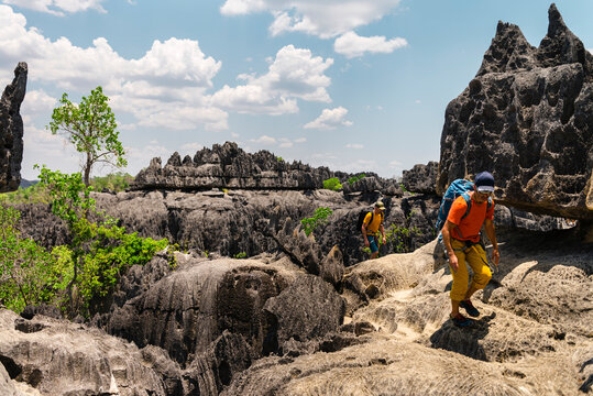 Male explorers walking on stony terrain