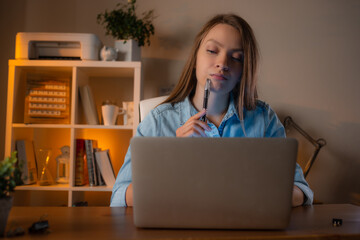 Yong tired woman working at her home office and use computer. Works moments concept. Attractive businesswoman studying online, software, web surfing information.