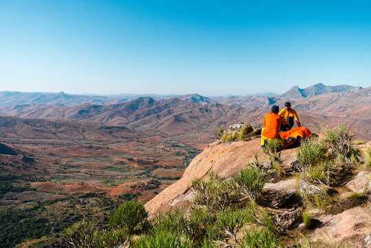 Hikers installing tent in mountainous terrain