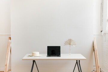 still life of laptop on desk in modern bright studio office space