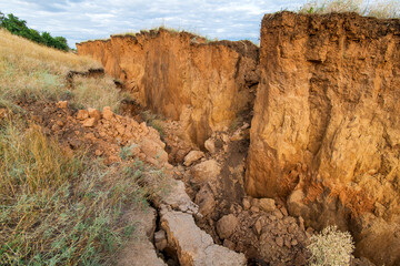 Soil landslide on slopes after degradation of the soil rain or underground water and an earthquake,...