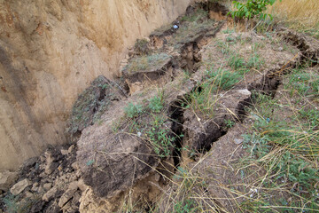 Soil landslide on slopes after degradation of the soil rain or underground water and an earthquake,...