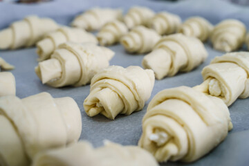 Close up on raw cheese croissants ready for baking - uncooked food
