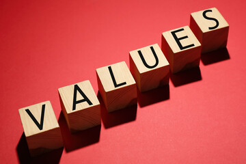 Obraz premium Wooden cubes with word VALUES on red background