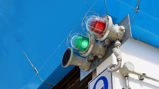 Industrial explosion-proof lantern, obstacle light, the light and sound alarm system at the fire On the background of the building wall with the copy space. Close focus and select an object