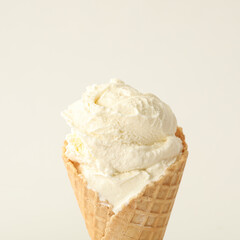 Delicious ice cream in waffle cone on white background, closeup