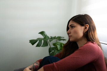 Fototapeta premium Hispanic woman in her 20s looking lonely and melancholic