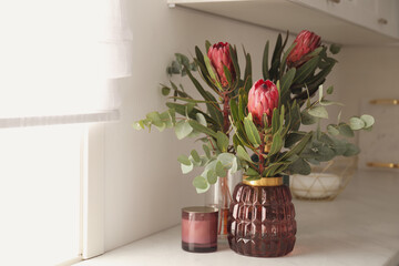 Beautiful protea flowers on countertop in kitchen. Interior design