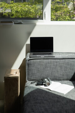 bright comfortable home office of a creative with laptop and film super 8 camera