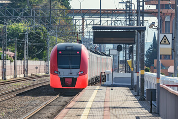 Obraz premium Passenger train departs from Dagomys station. Sochi.