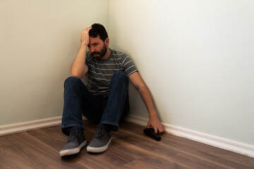 Hopeless man with suicidal thoughts holding a pistol